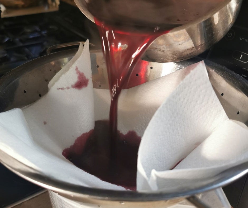 Elderberry juice being strained