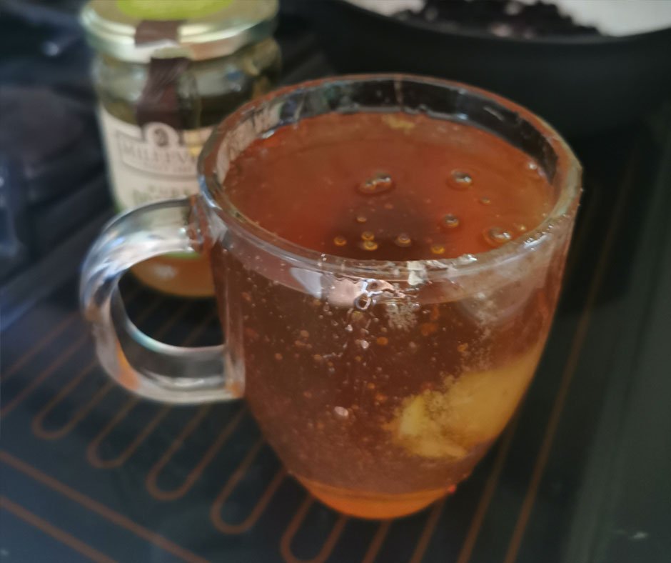 Elderberry syrup in a cup